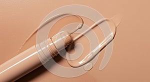 Beige Matte Cosmetic Stick with Glossy Swatch on Textured Surface, Isolated on White Background photo