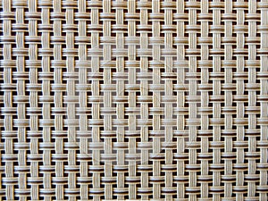 Close-up of beige fabric plastic lattice, grid texture; pattern of horizontal and vertical interwoven lines