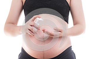 Close-up of belly pregnant standing with bottle pump isolate on