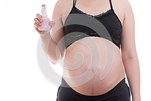 Close-up of belly pregnant standing with bottle pump isolate on white background