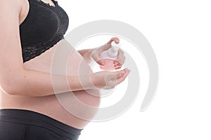 Close-up of belly pregnant standing with bottle pump isolate on white background