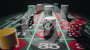 Close up of bet stacks of chips on a green casino roulette table. Concept of gambling or poker betting and entertainment