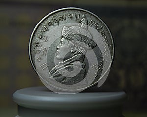 Close-up of a Bhutanese ngultrum coin against a dark background