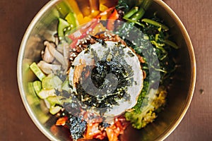 Close up of Bibimbap or Korean rice dish served on table.