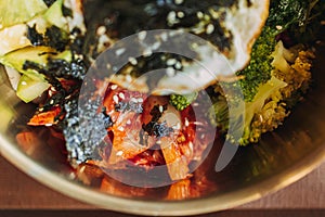 Close up of Bibimbap or Korean rice dish served on table.