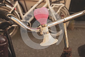 Close up of bicycle bell as a heart on handlebars