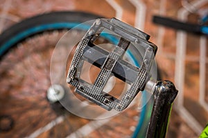 Close up of Bicycle pedal fixed by a mechanic in a workshop, in blurred background photo