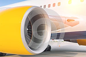 Close-up big commercial plane engine standing on airfiled after aircraft arrival on bright sunny day