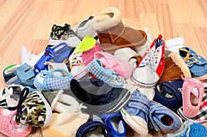 Close up on big pile of baby shoes.