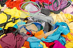 Close up on a big pile of clothes and accessories thrown on the ground. photo