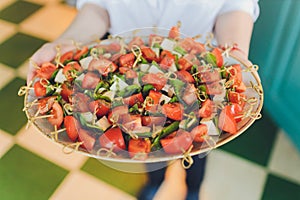 Close-up big plate with serving snack canapes fried bread tomato parsley and salami.