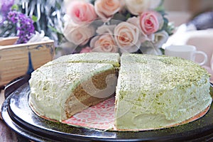 Close up big pound of green tea cake sliced on table top