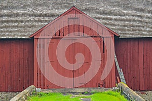 Close up of a big red barn with large double doors in Chaddsforge Pa.