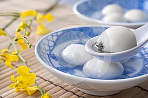 Close up of tangyuan in a bowl on gray table, food for Winter Solstice photo