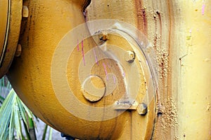 Close up of a big yellow pipe of big water pump machine