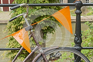 Close up of a bike decorated with orange flags