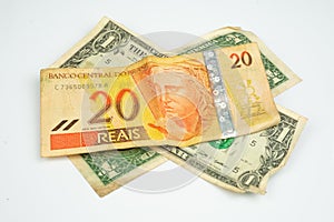 Close up of a bill of 20 Brazilian reals and one US dollar bill