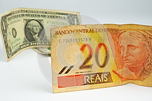 Close up of a bill of 20 Brazilian reals and one US dollar bill