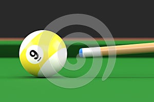 Close-up of billiard ball number nine in yellow and white color on billiard table