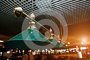 Close up of billiard lamps over pool