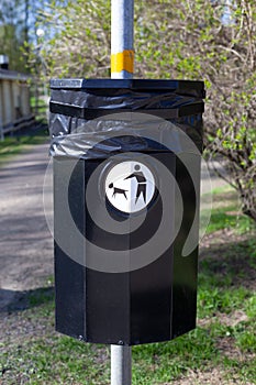 Close up of a bin specifically used for disposing of dog waste conceptualising. Dog poo waste litter bin.