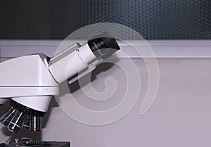 Close-up of a binocular microscope in the laboratory research, health concept