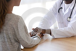 Close up of biracial doctor show support to female patient