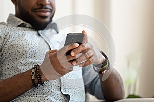 Close up of biracial male using cellphone texting