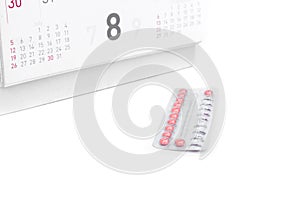 Close up birth-control pill with date of calendar background, he