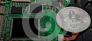 Close-up of bitcoin, computer circuit board with bitcoin processor and microchips. Electronic currency, internet finance rypto cur