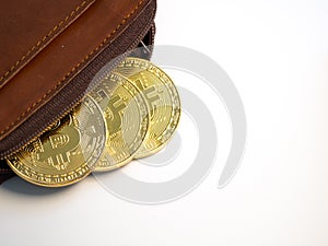 Close up bitcoin gold coins with wallet on the white background. Virtual cryptocurrency concept.