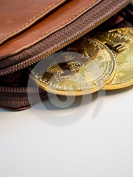 Close up bitcoin gold coins with wallet on the white background. Virtual cryptocurrency concept