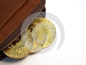Close up bitcoin gold coins with wallet on the white background. Virtual cryptocurrency concept