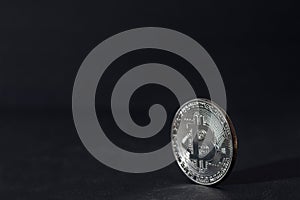 Close up of bitcoin, silver bitcoin, bitcoin with blurred background