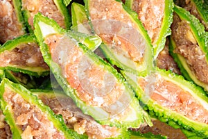 Close up bitter gourd pile with stuffed hack pork and garlic black pepper ingredient. vegetable herb Nourish the health body