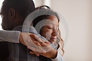 Close up black African wife embracing husband