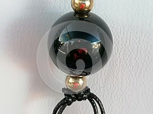 Close-up of black ball necklace.