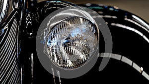 Close Up Of Black Classic Car Headlight