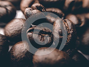 Close up of Black coffee beans with a natural bitter taste, with blurry background