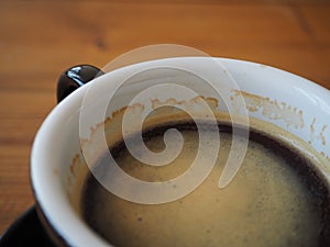 Close up black coffee in cup. focus on bubble