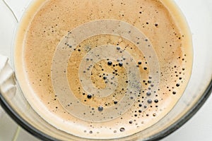 Close-up black coffee espresso in glass cup, top view.