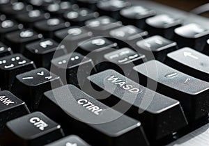 Close-up of a black computer keyboard emphasizing the WASD and CTRL keys