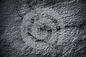 Black or dark grey stone texture with nature patterns on background