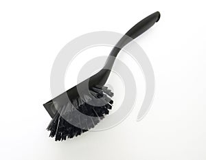 Close-up of black dishwasher brush with bristles and handle in horizontal position. Close up of Cleaning utensil made with