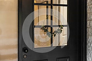 Close-Up of Black Door with Minimalist Decorative Wreath