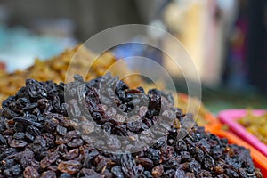 Close up of black dried grapes for sale in local market, Pune Maharashtra.