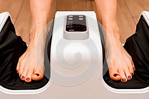 Close up of black foot massage device on wood floor