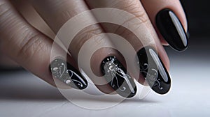 Close-up of black glossy stiletto nails