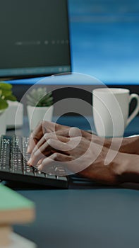 Close up of black hands coding server interface with binary codes
