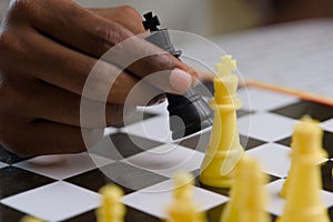 Close up of black man playing chess Concept of business competition and strategy